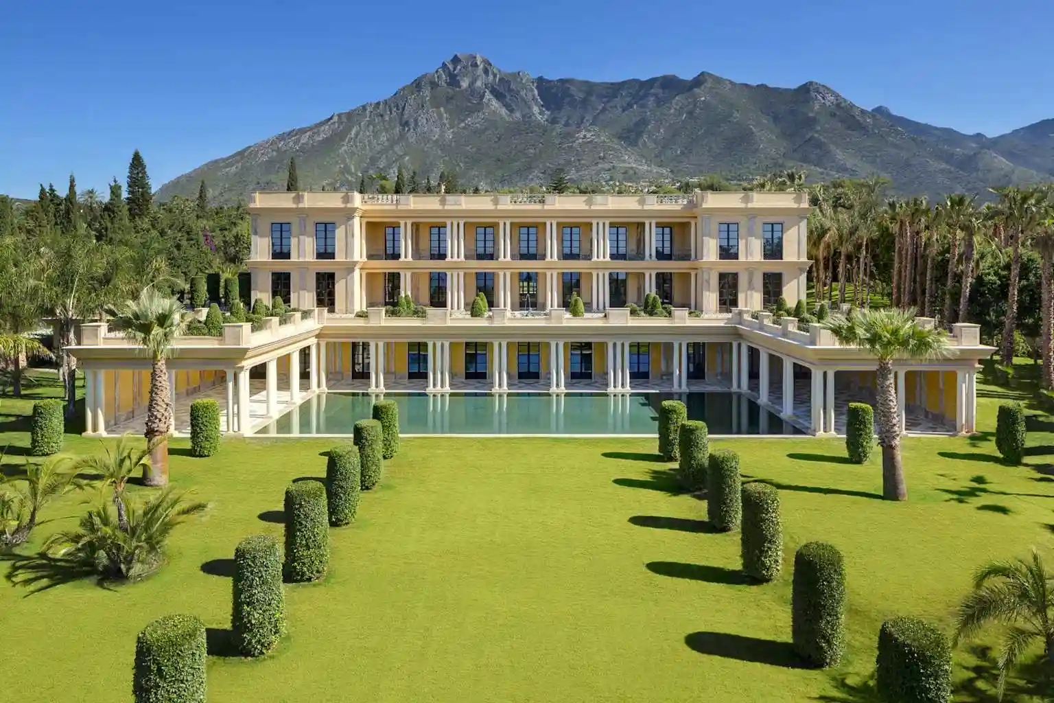 Luxurious villa with a large swimming pool and manicured gardens